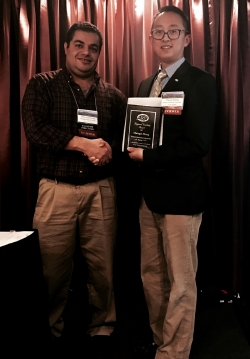 Dr. Zhang (right) accepts the ASC Regional Teaching Award